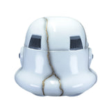 A white stormtrooper helmet with a decorative gold crack running vertically down the center and dark gray vent details.